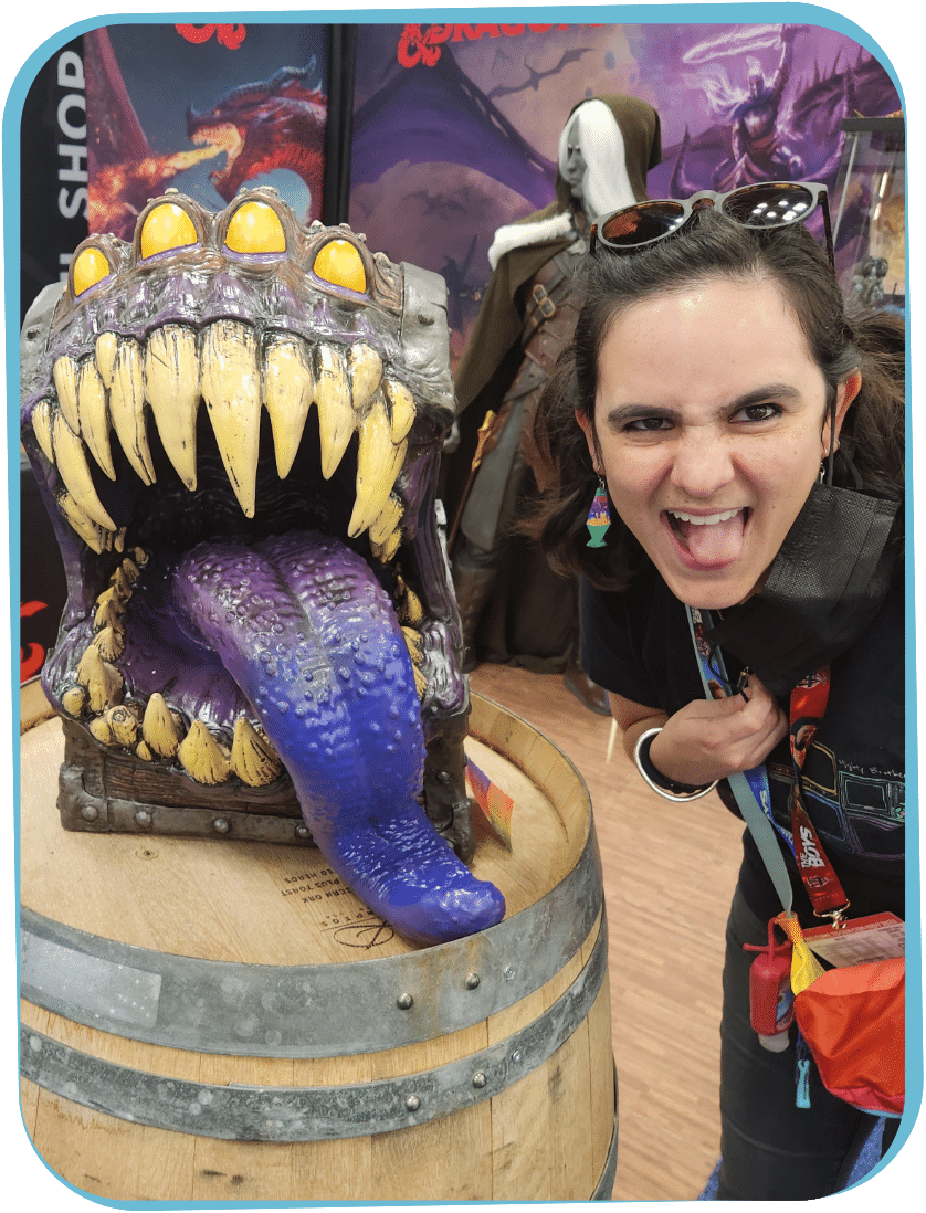woman next to monster figure with purple tongue out